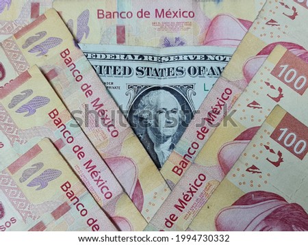 approach to american one dollar bill and mexican banknotes of 100 pesos