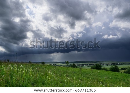 Approaching supercell thunderstorm in the village, squall line, storm clouds