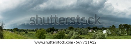 Approaching supercell thunderstorm in the village, squall line, storm clouds