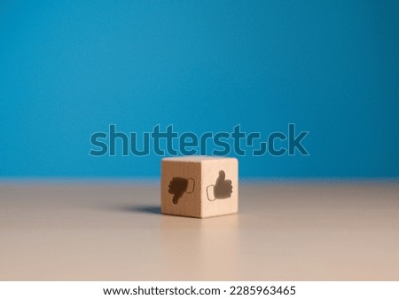 Approval or refusal. Thumb up and down icon on wooden cube face. Accepted or Rejected concept. Like and Dislike icons on opposite side of wooden block. Client service rating, satisfaction concept