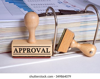 Approval rubber stamp with binder on desk in the office - Shutterstock ID 349864079