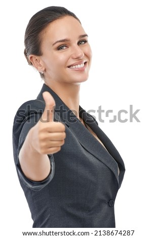 I approve. A businesswoman showing a thumbs-up to the camera.