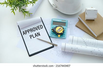 APPROVE PLAN sheet of paper with text on a paper tablet.