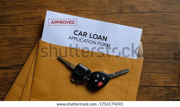 Approved car\
loan application form lay down on\
desk.