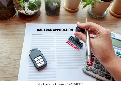 Approved Car Loan Application With Car Key, Rubber Stamp And Calculator Concept