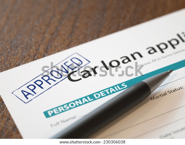 Approved car loan\
application with pen