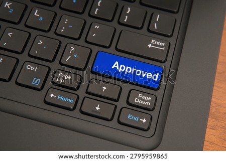 Approved concept on computer keyboard with highlighted key, representing confirmation, authorization, business decision, success, validation, and digital workflow completion.