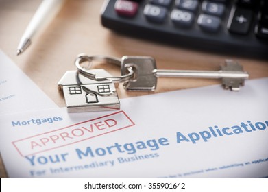 Approved mortgage loan agreement application with house shaped keyring