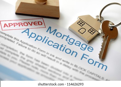 Approved Mortgage loan application and house key   rubber stamp
