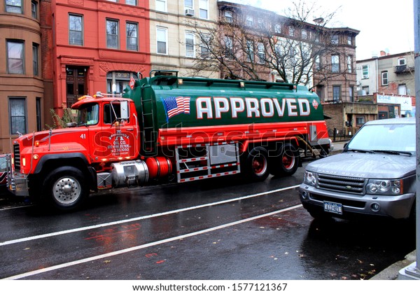 Approved Oil Company, green and red Approved Oil\
Company truck  in crown heights Brooklyn NY on a fall day December\
2 2019