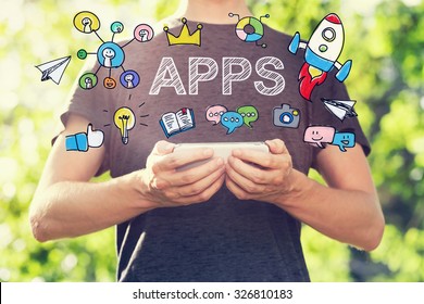 APPS concept with young man holding his smartphone outside in the park toward sunset - Shutterstock ID 326810183