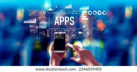 Apps theme with person using a smartphone in a city at night