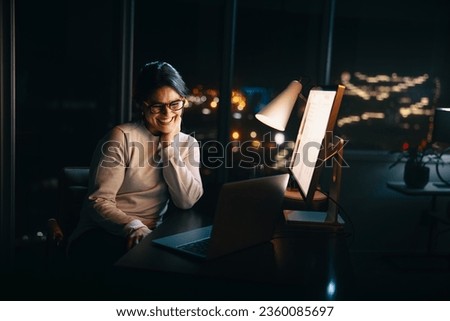 appy businesswoman working late from her home office, engaging in a productive video call with colleagues. She is dedicated to her remote work, and showcases the benefits of flexible schedules