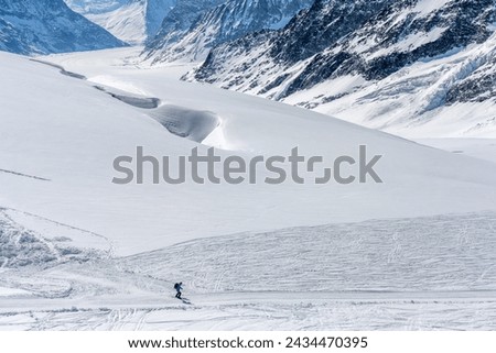 Apr 14, 2022 - Jungfraujoch, Swiss: A skier alone in the snow mountain.