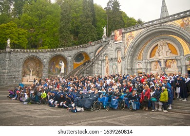 Apr 28. 2014 Lourdes France Christian pilgrims take a group photo in front of Rosary Basilica to commemorate their visit.