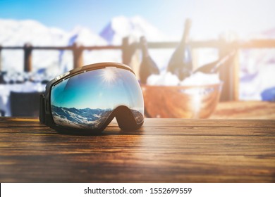 Apres Ski - Goggles With Mountains Reflection On The Restaurant Table At Ski Resort