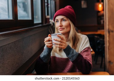 Apres Ski, A Woman In A Coffee Sitting In A Cozy Bar Drinks Coffee.