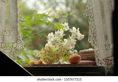 Apricot, cherry and Jasmine flowers on the window