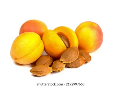 Apricot kernels and apricots against white background - Shutterstock ID 2192997663