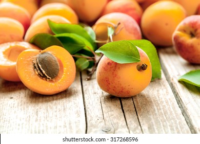 Apricot. Organic fruits with leaf on wooden background