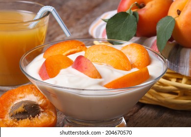Apricot yogurt and fresh juice closeup on wooden table horizontal 