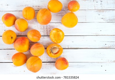 Apricots. Ripe fresh apricots on a wooden white background, top view, space for text. - Powered by Shutterstock