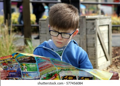 April 04 2016 - Windsor, UK: A Young Boy Studies The Map Of The Legoland Theme Park