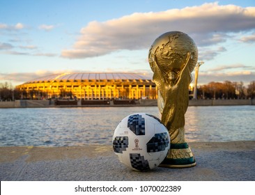 April 13, 2018 Moscow, Russia Trophy of the FIFA World Cup and official ball of FIFA World Cup 2018 Adidas Telstar 18  against the backdrop of the Luzhniki stadium in Moscow.