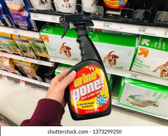 April 15, 2019 - Minneapolis, MN: Woman Shopper In A Pet Store Holds Up A Bottle Of Urine Gone, A Pet And Human Stain And Odor Remover 