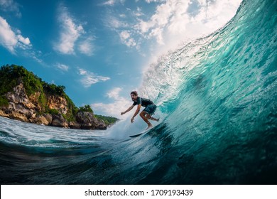 April 17, 2019. Bali, Indonesia. Surfer Ride On Surfboard At Barrel Wave. Professional Surfing In Ocean