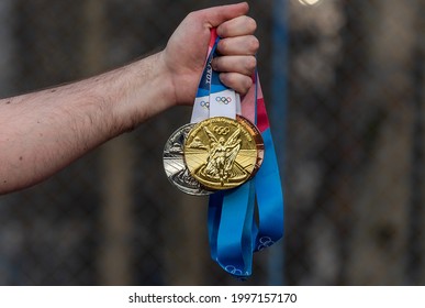 April 17, 2021 Tokyo, Japan. Gold, silver and bronze medals of the XXXII Summer Olympic Games in Tokyo in the hand of an athlete.