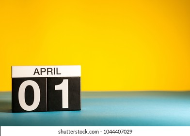 April 1st. Day 1 Of April Month, Calendar On Table With Yellow Background. Spring Time, Empty Space For Text