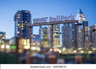 April 2017 Charlotte NC USA - BB&T baseball park sign and charlotte skyline with tilt effect in the morning