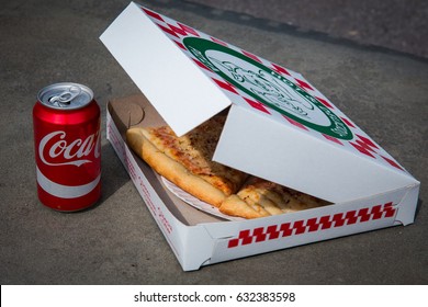 April 2017 - New York - Legendary New York 0.99 Cents Slice Pizza In Box And Can Of Coca-cola On Grey Background