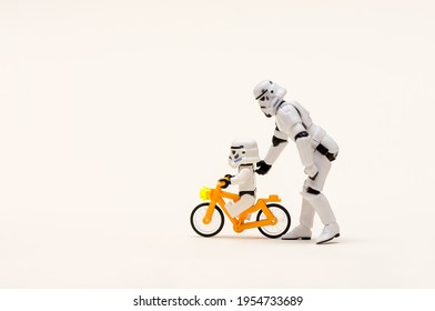 April 2021, mini figure of storm troopers riding a bike, white background