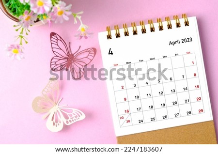 April 2023 desk calendar for the organizer to plan and reminder and paer butterfly on pink colour background. Imagine de stoc © 