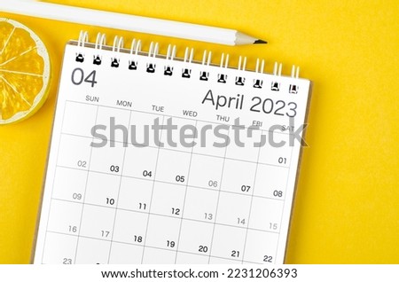 April 2023 Monthly desk calendar for 2023 year with wooden pencil on yellow background. 商業照片 © 