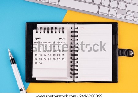 April 2024 calendar, notepad, pen and computer keyboard