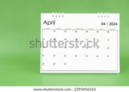 April 2024 desk calendar isolated in green color background.