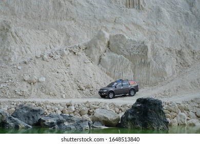 April 22, 2017, Madura, Indonesia. The Pajero Sports Car Passes Over A Limestone Hill With A Lake Edge