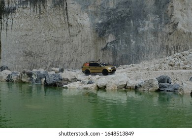 April 22, 2017, Madura, Indonesia. The Pajero Sports Car Passes Over A Limestone Hill With A Lake Edge