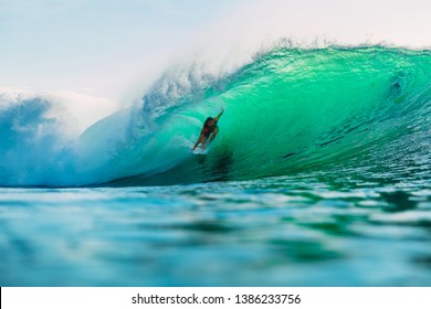 April 25, 2019. Bali, Indonesia. Surfer Ride On Barrel Wave. Professional Surfing With Ideal Ocean Waves At Bingin Beach