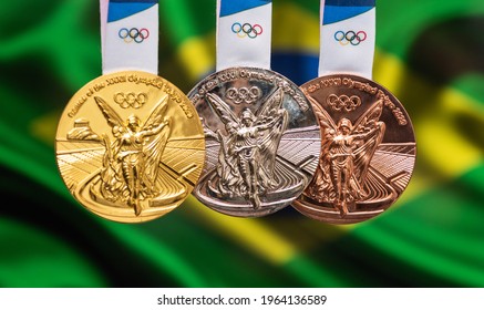 April 25, 2021 Tokyo, Japan. Gold, silver and bronze medals of the XXXII Summer Olympic Games 2020 in Tokyo on the background of the flag of Brazil.