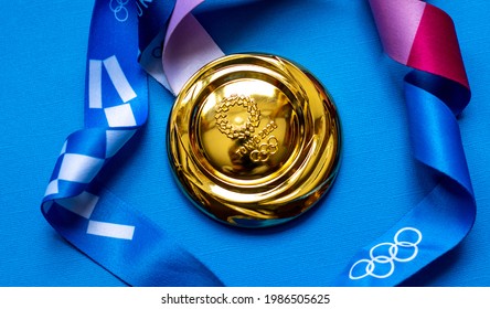 April 25, 2021 Tokyo, Japan. Gold Medal Of The XXXII Summer Olympic Games In Tokyo On A Blue Background.