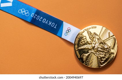 April 25, 2021 Tokyo, Japan. Gold Medal Of The XXXII Summer Olympic Games In Tokyo On A Yellow Background.