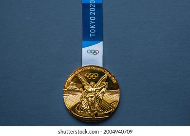 April 25, 2021 Tokyo, Japan. Gold Medal Of The XXXII Summer Olympic Games In Tokyo On A Blue Background.