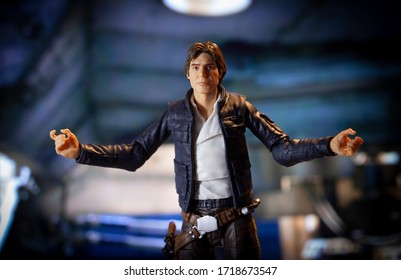 APRIL 29 2020: Recreation of a scene from Star Wars The Empire Strikes Back where Han Solo makes a gesture in front of the Millennium Falcon - Hasbro action figure