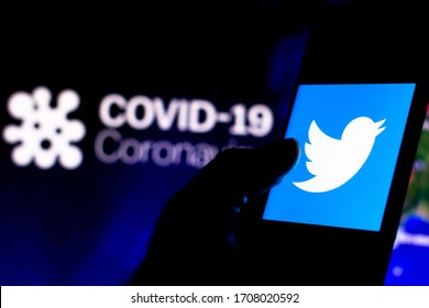 April 8, 2020, Brazil. In this photo illustration the Twitter logo seen displayed on a smartphone with a computer model of the COVID-19 coronavirus in the background.