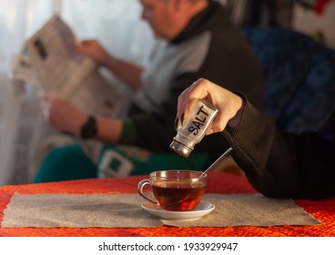 April Fools Day Joke: Girl Pours Salt Into Tea While Father Reads Newspaper