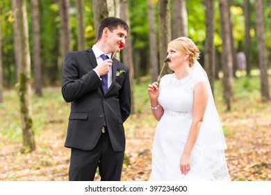 April Fools' Day. Wedding Couple Posing With Stick Lips, Mask.